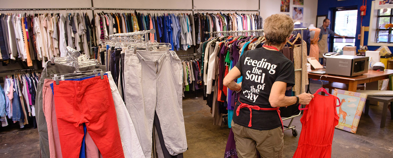 A Martha's Table volunteer stocks clothes at the organization's distribution center